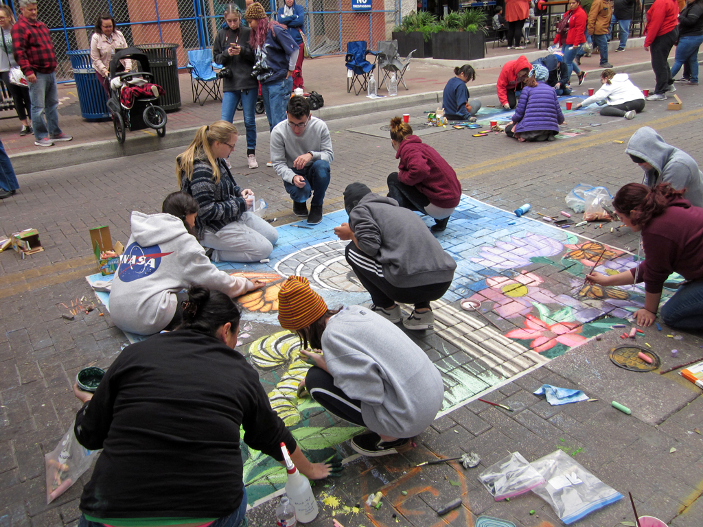 Photo of kids doing chalk art on street